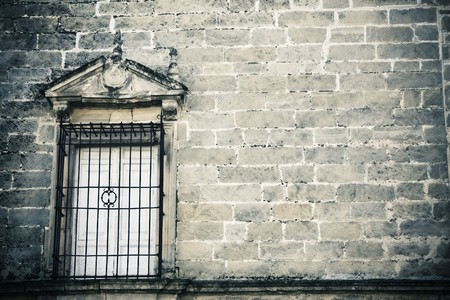 Old style window on creepy stonewallの写真素材
