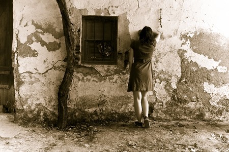 Young sad woman crying in wallの写真素材