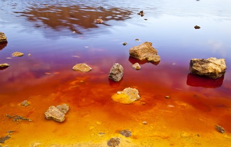 Colorful lake shore showing red, yellow and blue strong tones.の写真素材