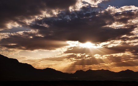 Lower sun covered by dark cloudsの写真素材