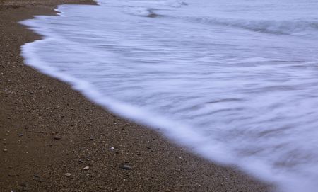Long exposed waves dying in the shore.の写真素材