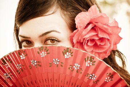 Spanish woman behind traditional fan.の写真素材