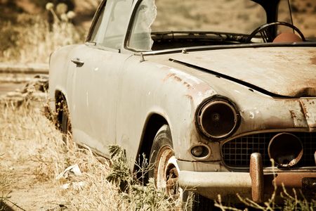 Abandoned vintage car in the middle of nowhereの写真素材