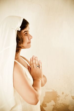 Young beautiful woman praying to her godの写真素材