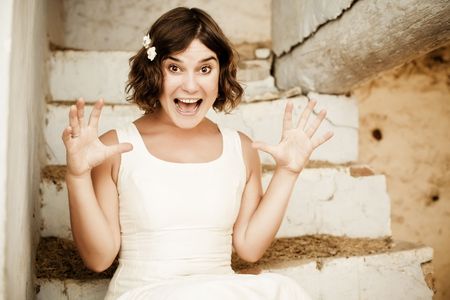 Young beautiful shocked woman in a rusty old house.の写真素材