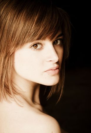 Young beautiful woman against black backgroundの写真素材