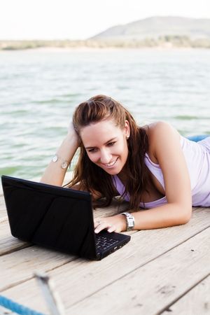 Young happy woman working with her laptopの写真素材