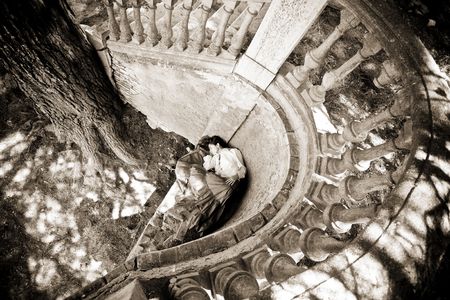 Asleep young girl surrounded by antique snail stairsの写真素材
