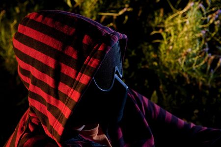 Masked man portrait, profile angle.の写真素材