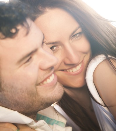 Closeup on young beautiful smiling couple.の写真素材