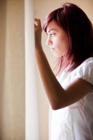 Window light on young beautiful girlの写真素材