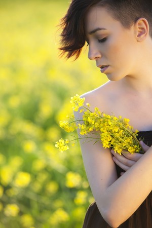 Young girl portrait holding yellow flowers