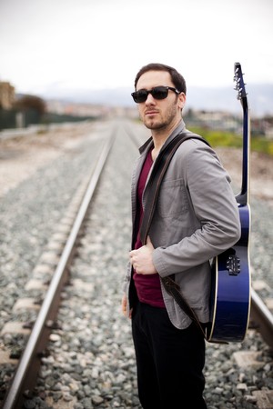 Lone handsome male musician on his wayの写真素材