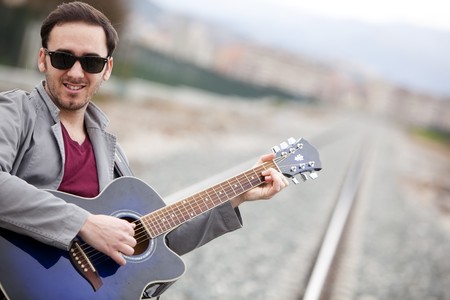 Lone handsome male musician on his way
