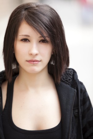 Young beautiful pierced girl staring at camera.の写真素材