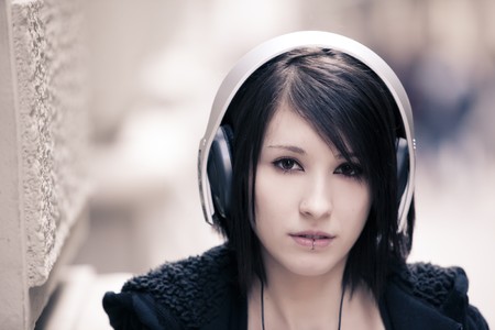 Young beautiful girl portrait wearing headphones.の写真素材