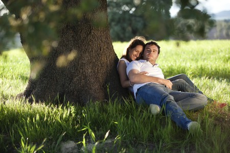Young beautiful couple under tree.の写真素材