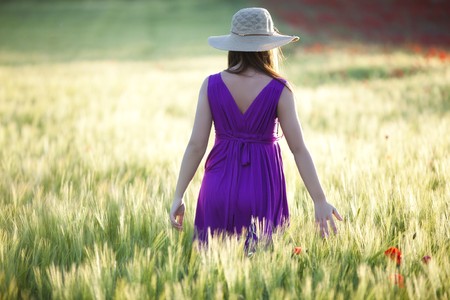 Young beautiful girl posing in a green field.の写真素材