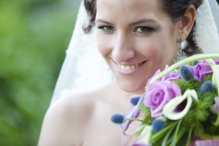 Young beautiful bride close portrait with bouquetの写真素材