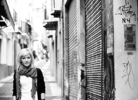 Young blond girl portrait on slum street backgroundの写真素材