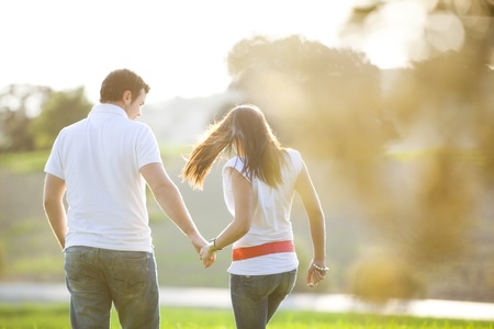 Young anonymous couple taking a walk on natureの写真素材