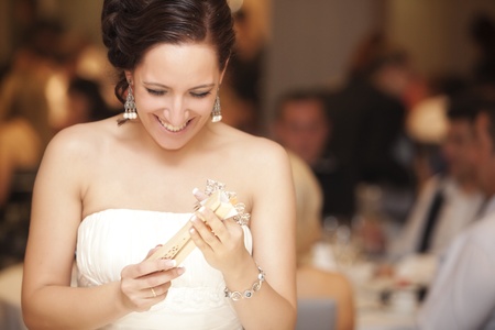 Actual bride looking her closed fan very happy on her weddingの写真素材