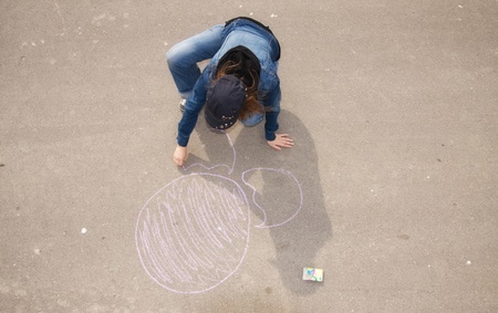 Young artist painting on the streetの写真素材