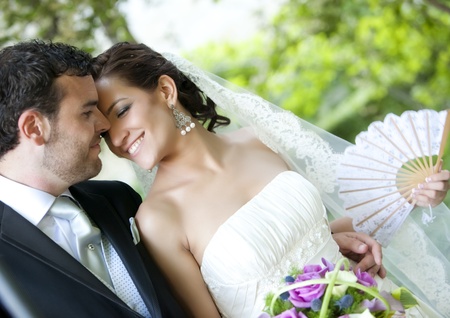 Groom kissing bride on their wedding day.の写真素材