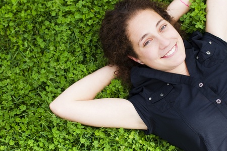 Young happy girl smiling at capera over the grassの写真素材