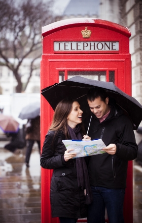 Sweet honeymoon couple consulting map in Londonの写真素材