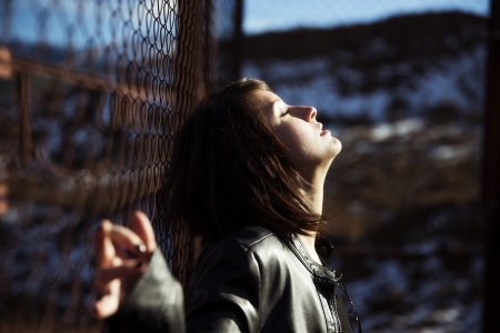 Emotional young woman portrait on urban blurry environmentの写真素材