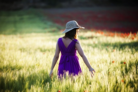 Young beautiful girl posing in a green field.の写真素材