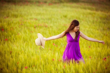 Young beautiful girl feeling freedom on meadowの写真素材