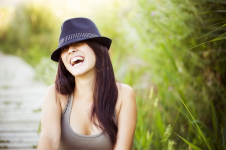 Cheerful young beautiful woman in natureの写真素材