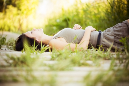 Young beautiful girl lying in nature.の写真素材