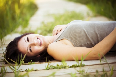 Young beautiful girl lying in nature.の写真素材