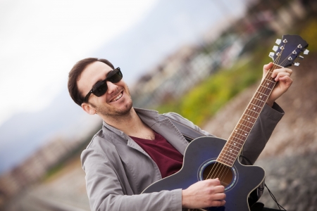 Lone handsome male musician on his wayの写真素材