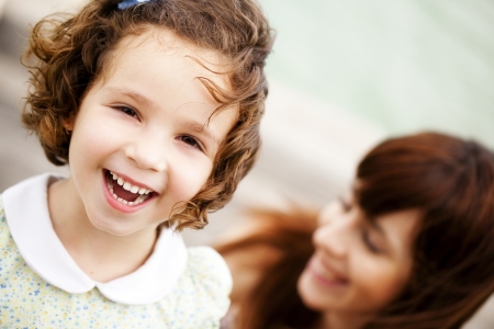 Little child portrait, with her smiling mother in a second termの写真素材