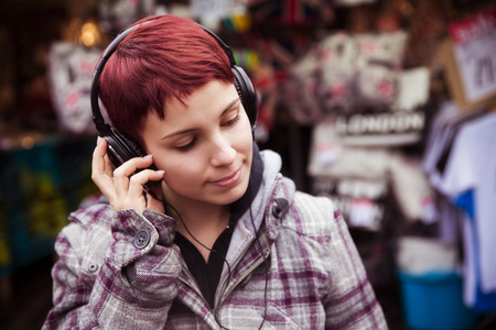 Young urban girl listening to musicの写真素材