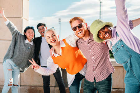 Five friends multi-ethnic posing in front of the camera smiling and having fun together outdoor.の写真素材