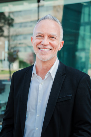 Vertical portrait of mature adult business man with gray hair and suit smiling and looking at camera with succesful attitude. Happy corporate lawyer with white perfect teethの写真素材