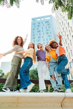 Vertical. Group of playful female friends having fun on a social meeting. Young friendly women...