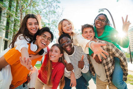 Big group of multiracial young student people smiling, gesturing and looking at camera. Happy...