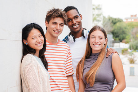 A diverse group of friends smiles joyfully outdoors, celebrating their bond while engaging in playful activities that reflect their vibrant lifestylesの写真素材