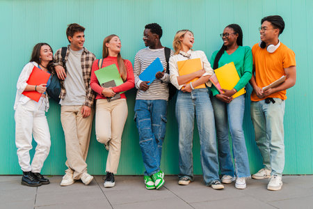 A large gathering of teenage students, their laughter echoing across the university campus as they engage in lively conversations. Classmates sharingの写真素材