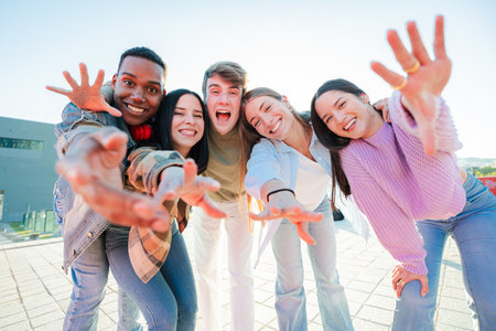 Excited Group of Diverse Teenagers Joyfully Gesturing and Posing With Outstretched Hands, Radiating...
