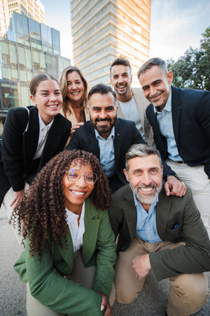 Vertical. Diverse group of business professionals smiling and looking at the camera during an...