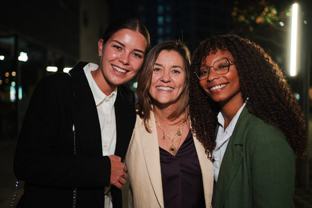 Three Cheerful Women Posing Together While Smiling at Camera. They Are Celebrating Their Friendship and Professional Connections in a Joyfulの写真素材