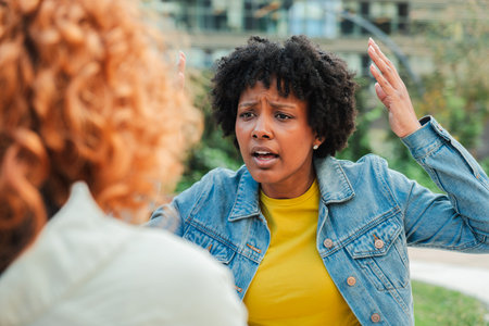 Intense emotional conversation between two women expressing frustration and resolving their differencesの写真素材