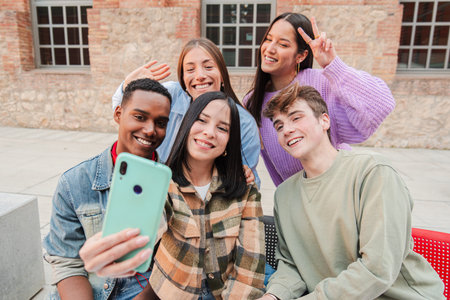 A Delightful Group of Friends Enjoying a Lighthearted Moment While Taking a Fun Selfie, Showcasing...
